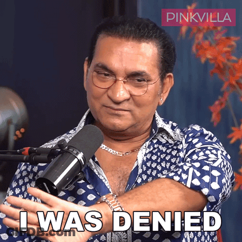 A Man In Front Of A Microphone With The Words I Was Denied Below Him GIF