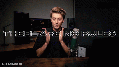 A Man In Front Of A Microphone With The Words There Are No Rules GIF