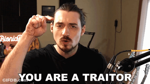 A Man In Front Of A Microphone With The Words " You Are A Traitor " On The Bottom GIF
