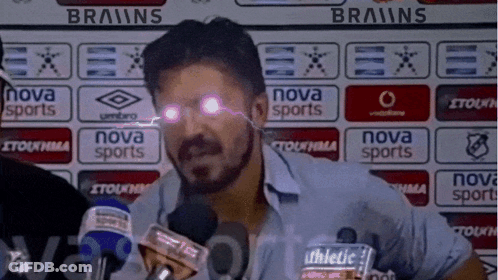 A Man In Front Of A Nova Sports Banner GIF