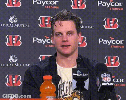 A Man In Front Of A Paycor Stadium Backdrop GIF