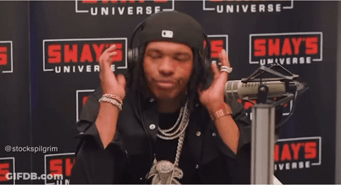 A Man In Front Of A Shaw 'S Universe Sign GIF