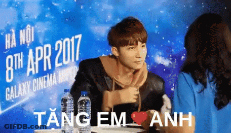A Man In Front Of A Sign That Says 8Th Apr 2017 GIF