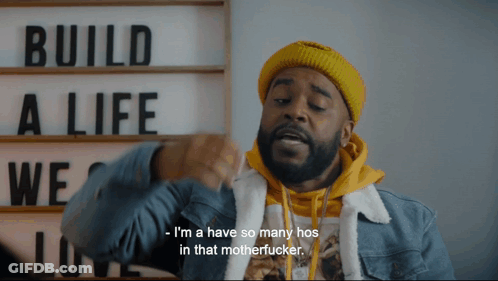 A Man In Front Of A Sign That Says " Build A Life " GIF