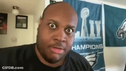 A Man In Front Of A Super Bowl Champions Flag GIF