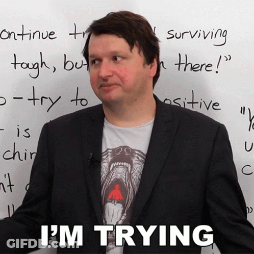 A Man In Front Of A White Board That Says I 'M Trying On It GIF