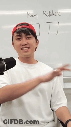 A Man In Front Of A White Board That Says Kanji Katakana On It GIF