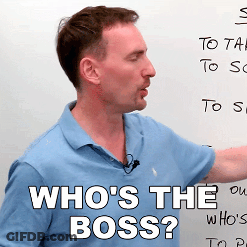 A Man In Front Of A White Board With The Words Who 'S The Boss Written On It GIF