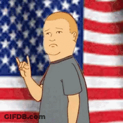 A Man In Front Of An American Flag Giving A Rock Sign GIF