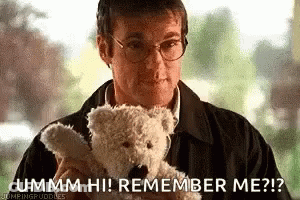 A Man In Glasses Is Holding A Teddy Bear And Saying `` Ummm Hi ! Remember Me ? '' . GIF
