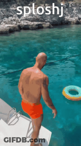 A Man In Orange Shorts Is Jumping Into A Body Of Water With The Word Splashj Above Him GIF