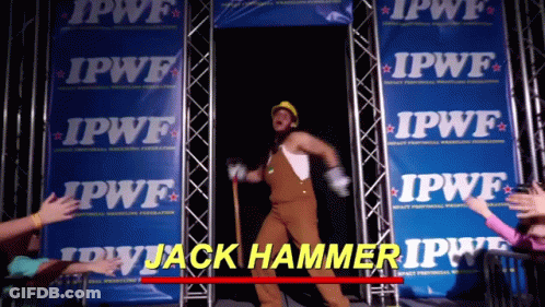 A Man In Overalls And A Hard Hat Is Standing In Front Of A Row Of Ipwf Banners GIF