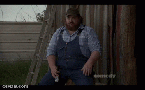 A Man In Overalls Is Sitting On A Ladder With The Words Allegedly Above Him GIF