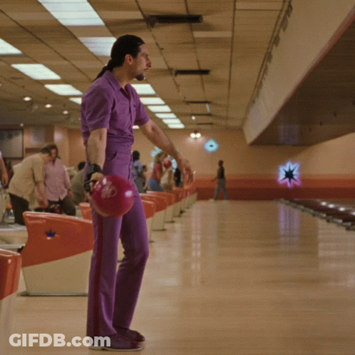 A Man In Purple Pants Holds A Red Bowling Ball With A Star On It GIF
