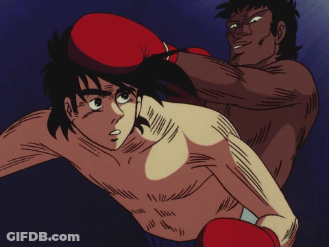 A Man In Red Boxing Gloves Is Fighting Another Man GIF