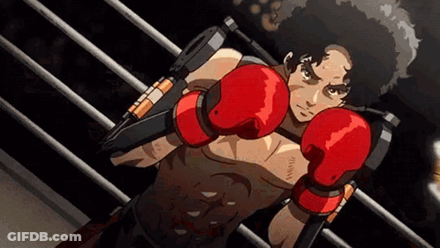A Man In Red Boxing Gloves Is Standing In A Ring . GIF