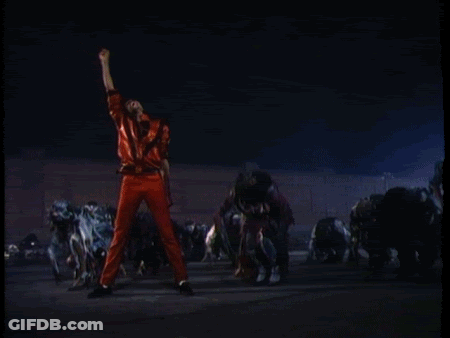 A Man In Red Pants Stands In Front Of A Crowd Of Zombies GIF