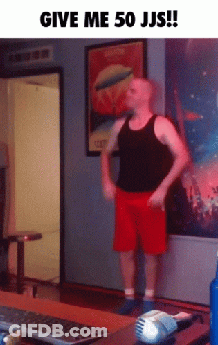 A Man In Red Shorts Is Standing In Front Of A Computer Keyboard GIF