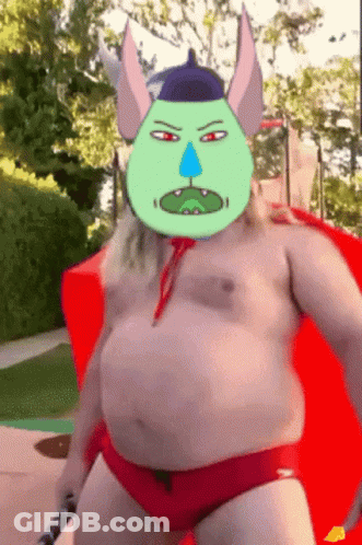 A Man In Red Swim Trunks Has A Cartoon Face On His Face GIF