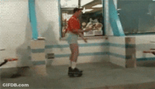 A Man In Shorts Is Rollerblading In A Fast Food Restaurant GIF