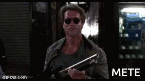 A Man In Sunglasses Is Holding A Shotgun And The Word Mete Is On The Bottom Right GIF