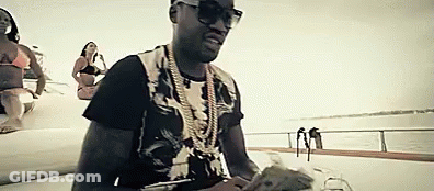 A Man In Sunglasses Is Sitting On A Boat Holding Money . GIF