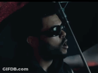 A Man In Sunglasses Is Smoking A Cigarette In A Car GIF