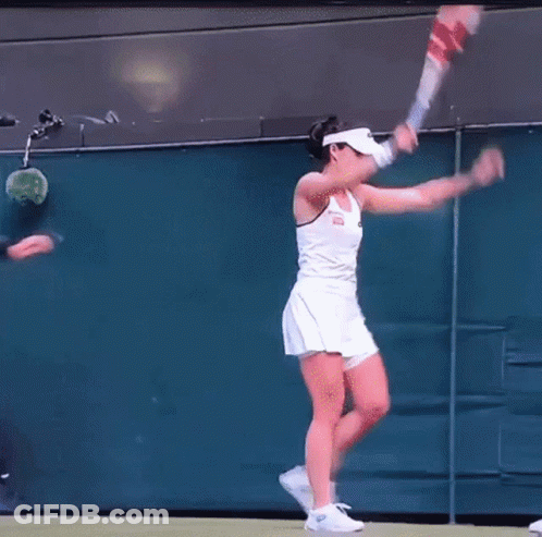 A Man In Sunglasses Is Standing Next To A Woman In A White Dress On A Tennis Court GIF