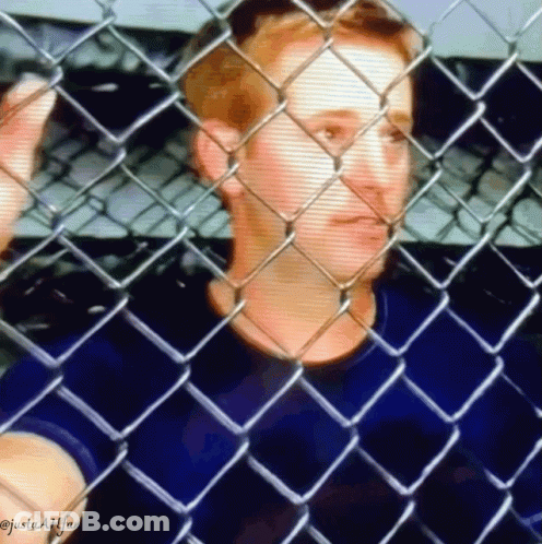 A Man Is Behind A Chain Link Fence And The Caption Says Justaafffan GIF