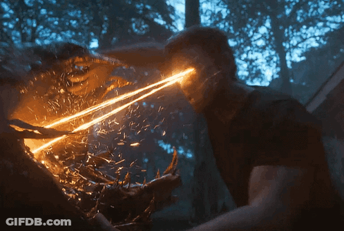 A Man Is Being Attacked By A Monster With A Light Coming Out Of His Eyes GIF