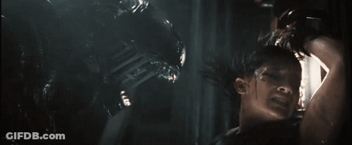A Man Is Being Attacked By An Alien In A Movie GIF