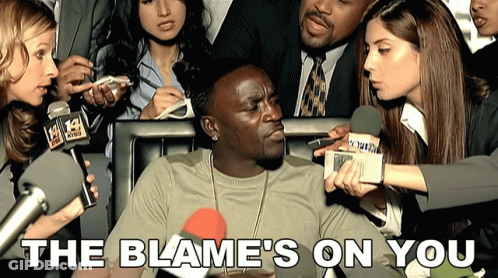 A Man Is Being Interviewed By A Group Of Reporters With The Words The Blame 'S On You Below Him GIF