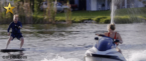 A Man Is Being Towed By A Jet Ski GIF