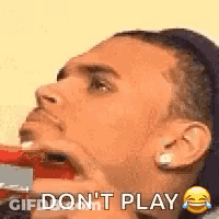 A Man Is Brushing His Teeth With A Toothbrush And Saying `` Don T Play '' . GIF
