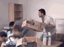 A Man Is Carrying A Box That Says Hp On The Front GIF
