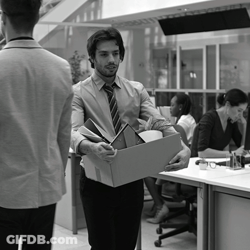 A Man Is Carrying A Cardboard Box With His Belongings GIF