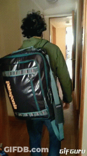 A Man Is Carrying A Large Patagonia Bag GIF