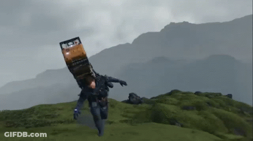 A Man Is Carrying A Truck On His Back While Running On A Hill . GIF