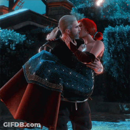 A Man Is Carrying A Woman In His Arms And Kissing Her On The Cheek GIF