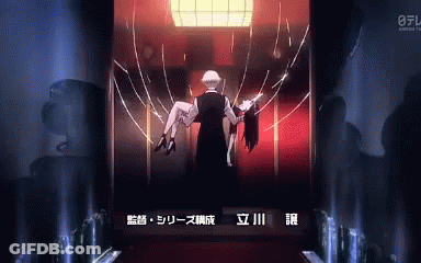 A Man Is Carrying A Woman In His Arms In A Dark Room GIF