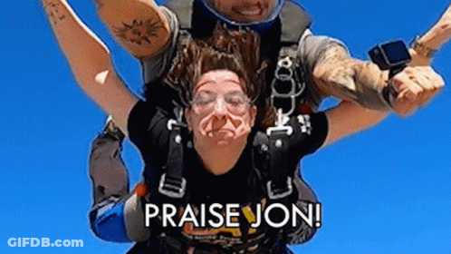 A Man Is Carrying A Woman In The Air With The Words `` Praise Jon '' On The Bottom . GIF