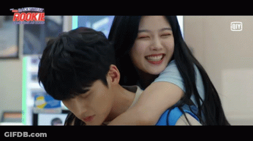A Man Is Carrying A Woman On His Back With The Word Rookie On The Bottom Left GIF