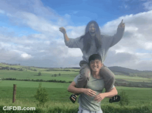 A Man Is Carrying A Woman On His Shoulders And The Woman Is Wearing A Shirt That Says " Abercrombie & Fitch " GIF