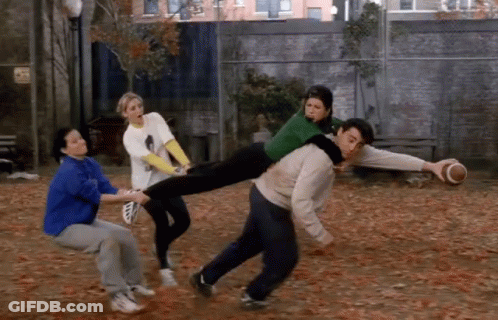 A Man Is Carrying A Woman On His Shoulders While A Group Of People Watch GIF
