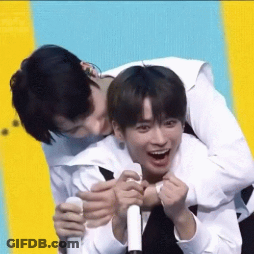 A Man Is Carrying Another Man On His Back And They Are Laughing . GIF