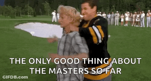 A Man Is Carrying Another Man On His Back On A Golf Course While A Crowd Watches . GIF