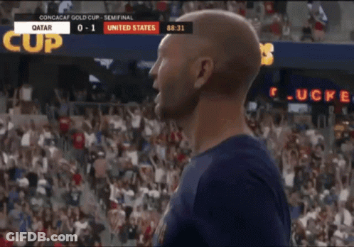 A Man Is Celebrating A Goal During A Soccer Game Between Qatar And The United States GIF