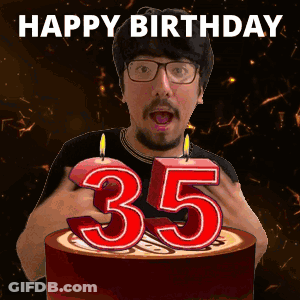 A Man Is Celebrating His 35Th Birthday By Blowing Out A Candle GIF
