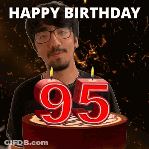 A Man Is Celebrating His 95Th Birthday By Blowing Out Candles On A Cake GIF