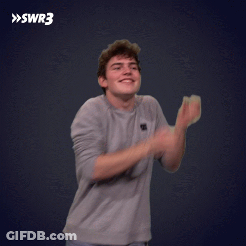 A Man Is Clapping His Hands In Front Of A Swr3 Sign GIF